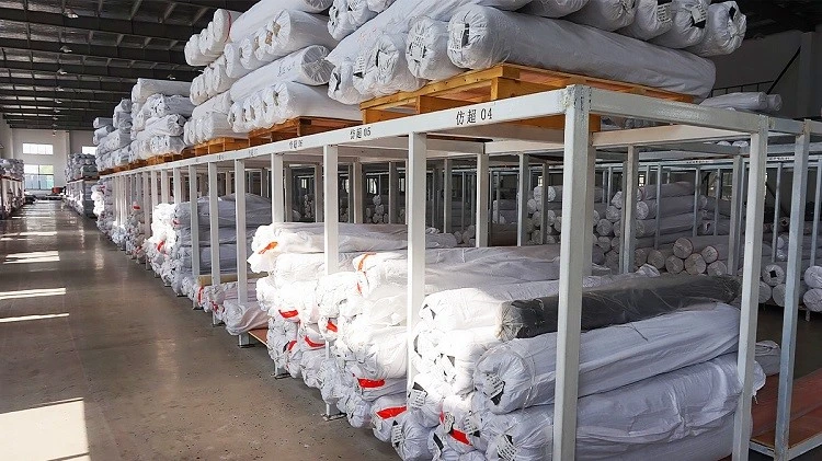 Bulk PVC leather rolls neatly stacked in warehouse Bulk PVC leather rolls neatly stacked in warehouse